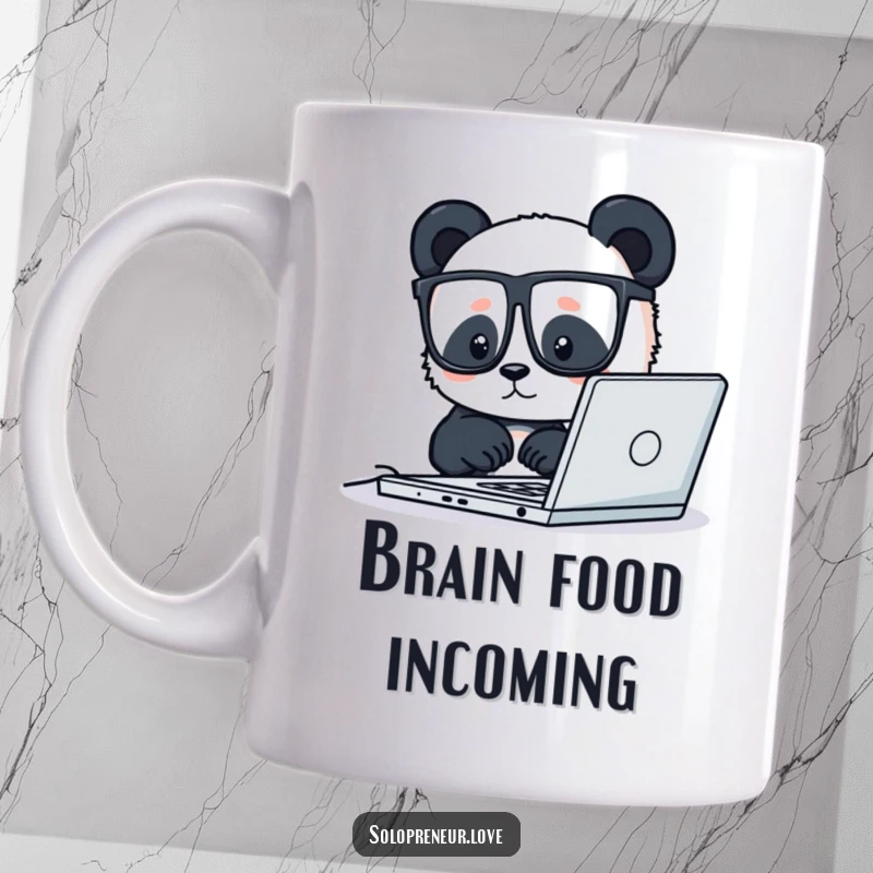 Funny mug showing a tiny panda wearing glasses, intently focused on its laptop screen, diligently working.