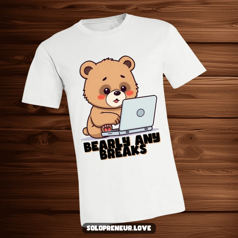 Funny T-Shirt depicting a small, determined bear cub intensely typing on a laptop, radiating focus and cute productivity.