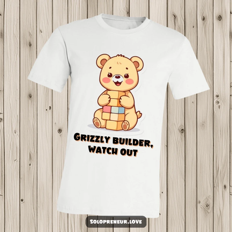 Funny t-shirt featuring a happy bear cub engrossed in building a small tower of blocks, capturing the essence of childhood play.