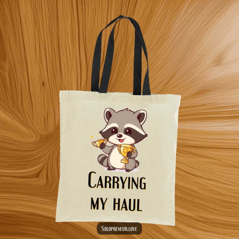 Funny tote bag showcasing a happy raccoon character meticulously polishing a small trophy, perfect for carrying daily items with charm.
