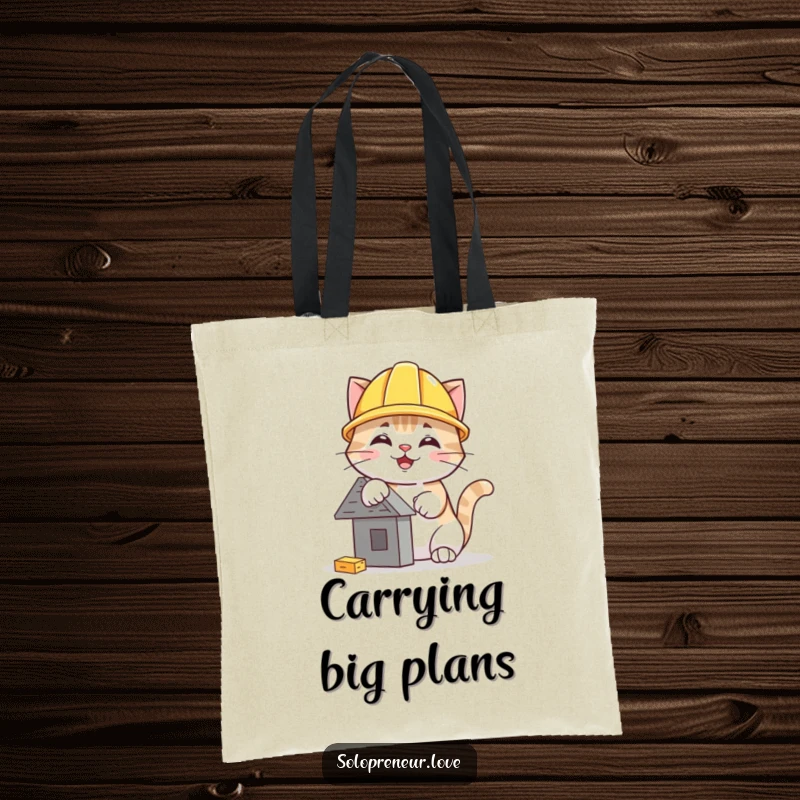 Funny cat hard hat tote bag depicting a cheerful cat in a helmet, focused on building a small, intricate structure.
